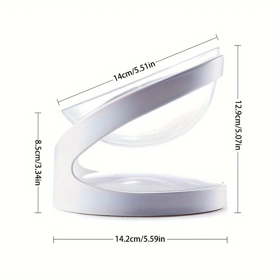 Clear plastic elevated cat food bowl with tilt design on white surface