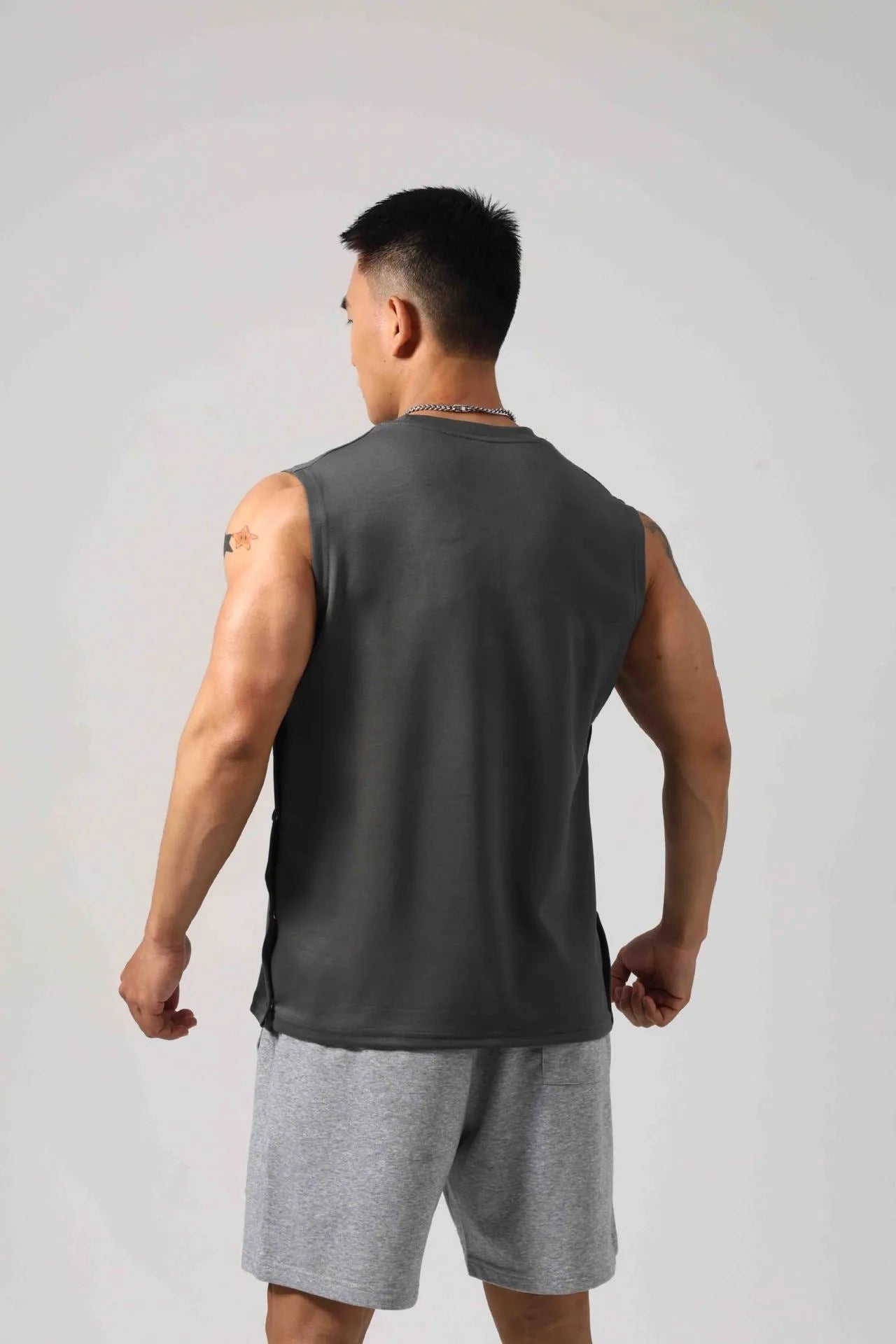 Korean style men's loose cotton fitness vest with hidden side hooks in black.