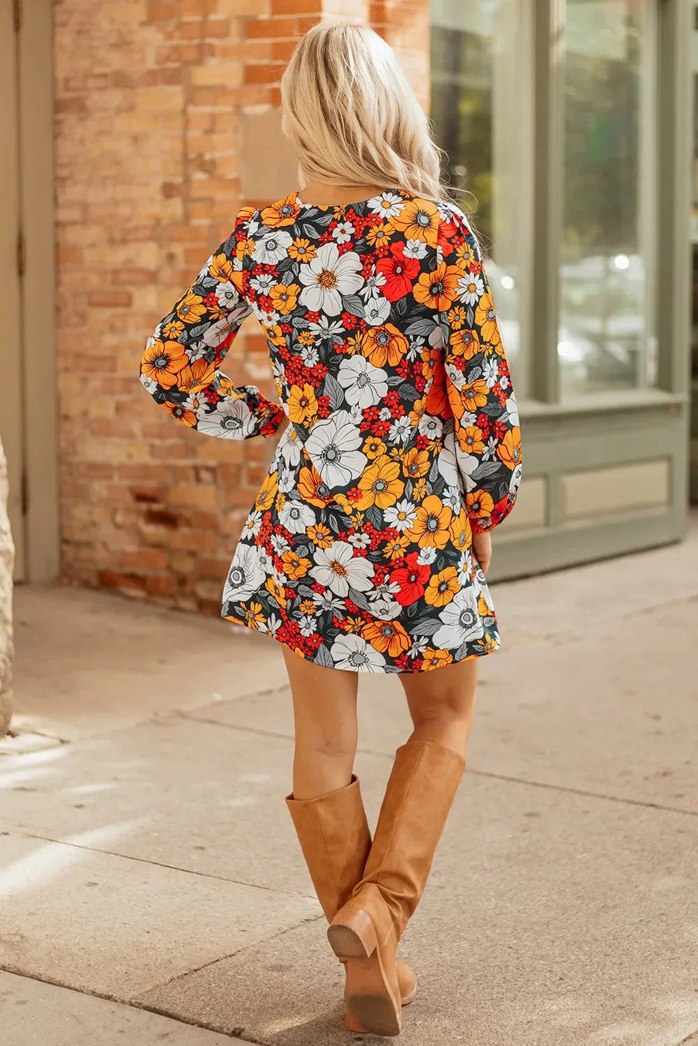 Orange floral print women's mini dress with V neck, long sleeves, and striped lace detail.