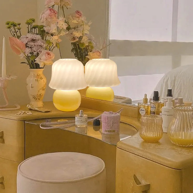 Handmade glazed glass mushroom lamp in cream yellow with push button switch on bedside table
