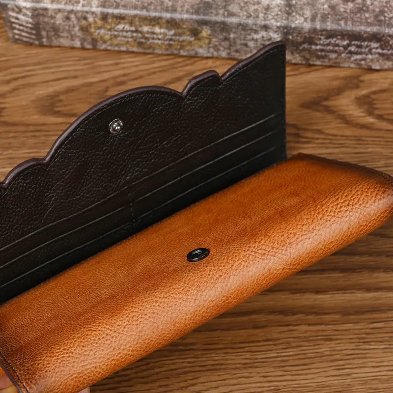Chinese style brown leather tri-fold wallet with a floral embossed pattern, shown open to reveal compartments.
