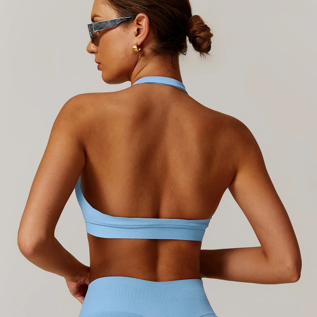Women's black halter sports bra with medium support for yoga and workouts.