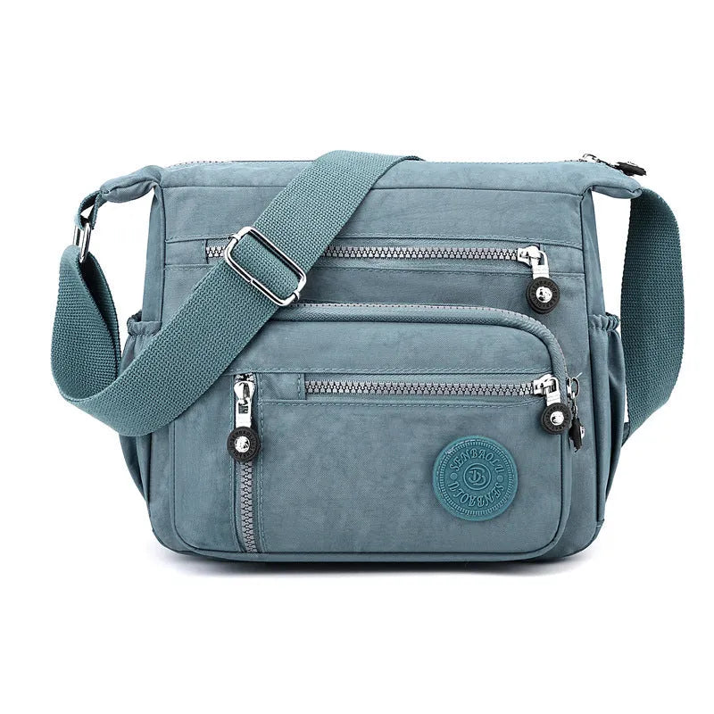 Grey lightweight nylon messenger bag with large capacity and single shoulder strap.