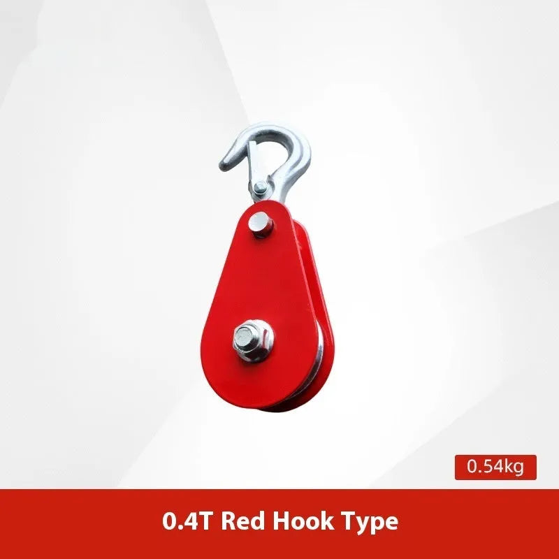 Red industrial steel lifting pulley with a safety latch on the hook.