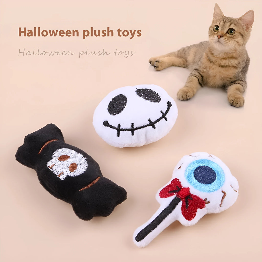 Small cat teaser wand with dangling plush candy, eye, and skull toy attachments