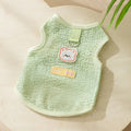 Hollowed-out cat clothes with bear patch in blue, green, yellow colours showing knitted fabric texture