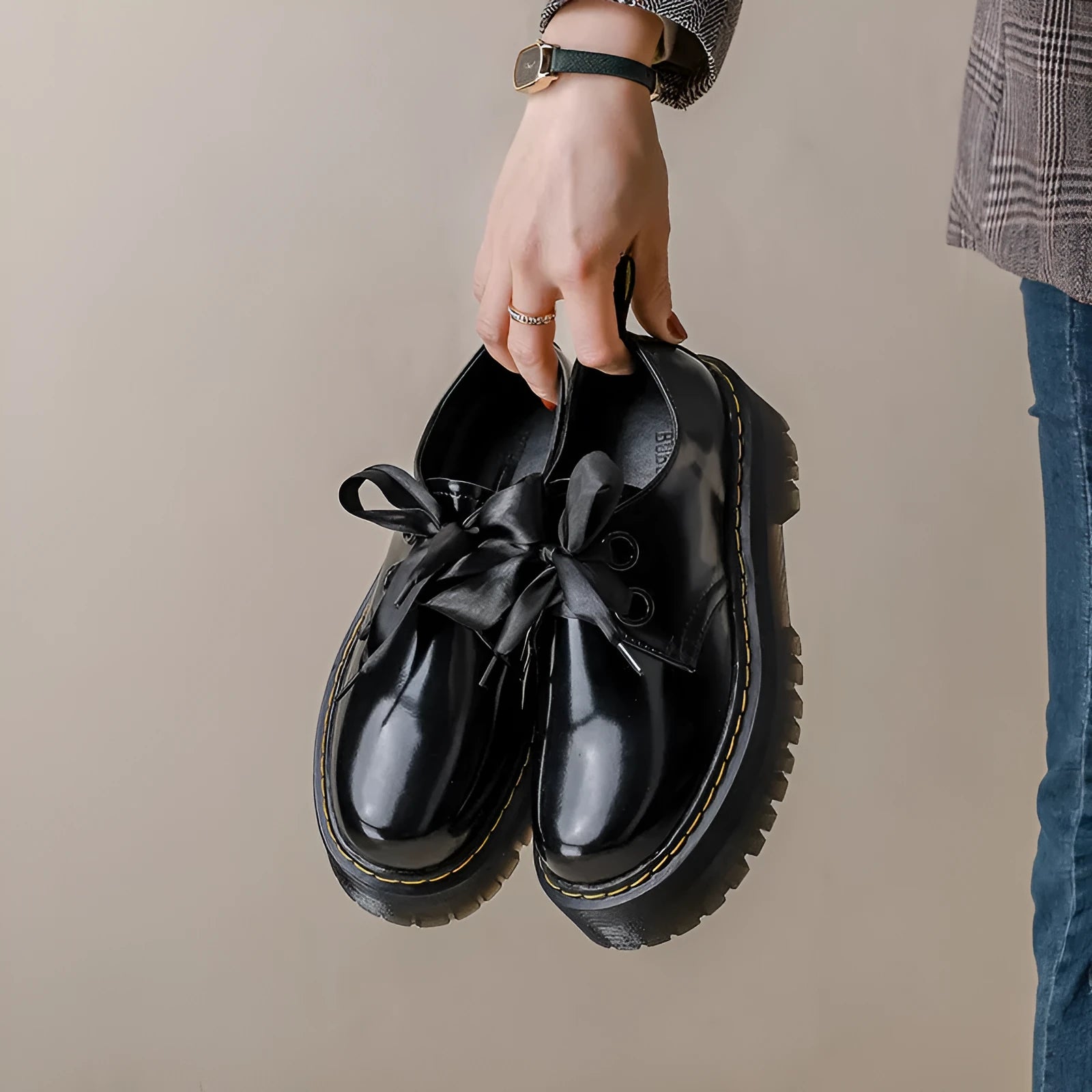 Women's white and black thick soled leather shoes with cross strap and ribbon detail on a superfine fibre upper.