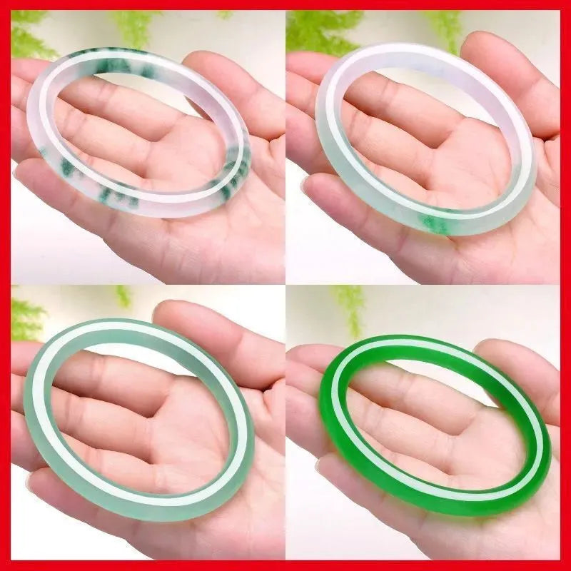 Jade bracelet with carved floating flower and auspicious cloud pattern in emerald green.