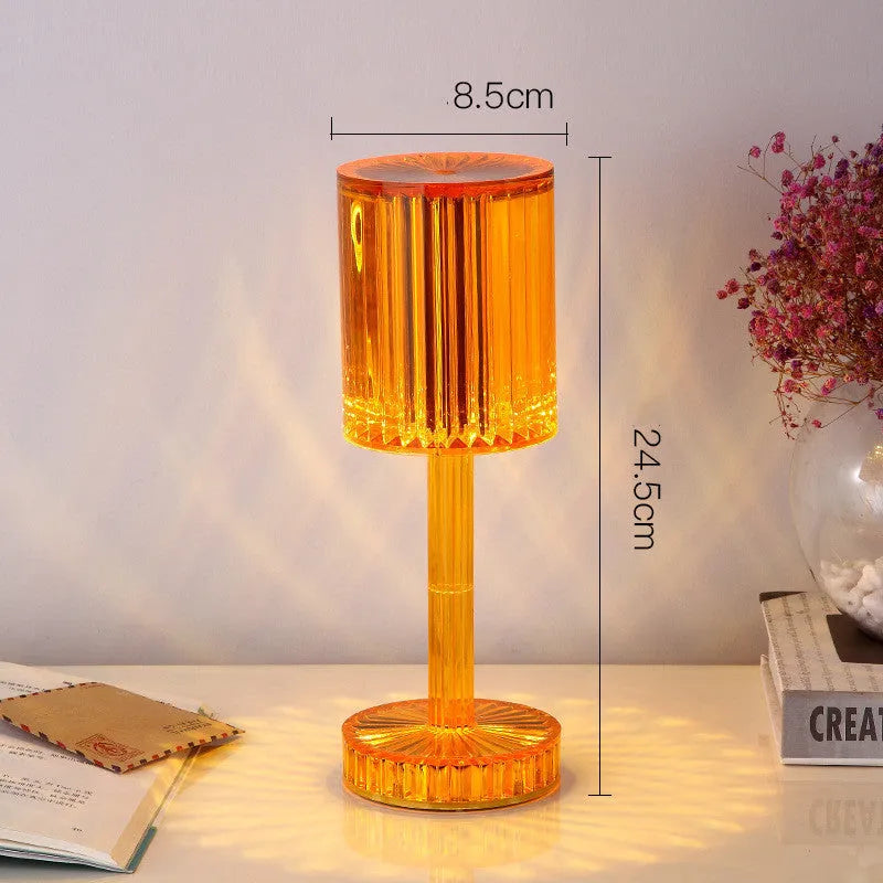 Amber K9 crystal table lamp with double-layered lampshade on a modern bedside table, warm LED light on medium brightness