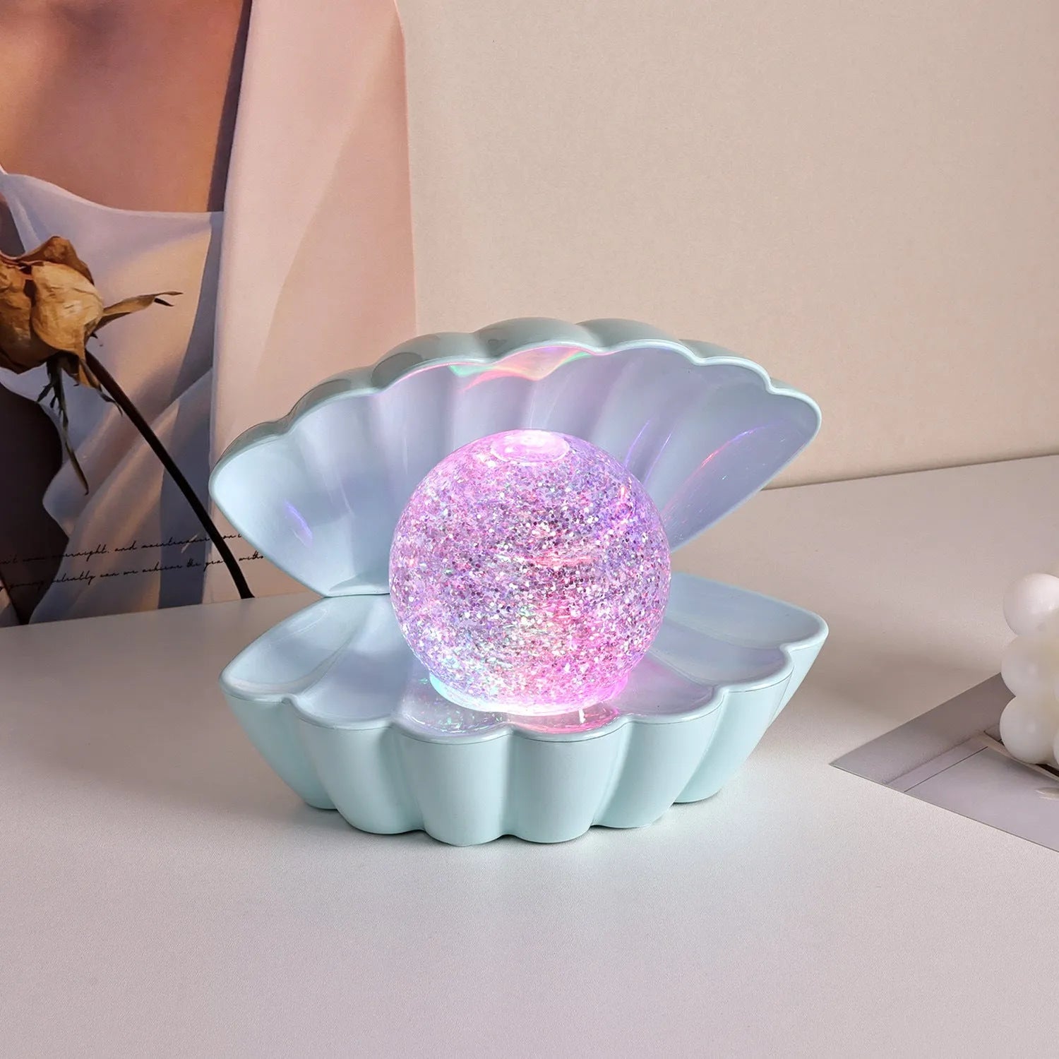 Shell-shaped small neon night lamp with battery power for ambience lighting.