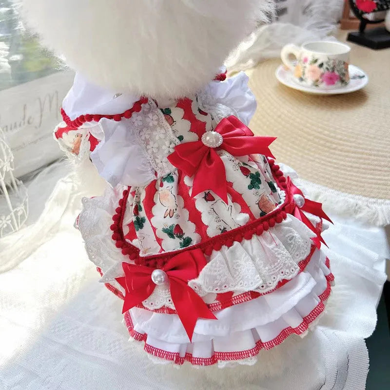 A small dog wearing a lightweight white and grey rabbit-themed princess skirt.