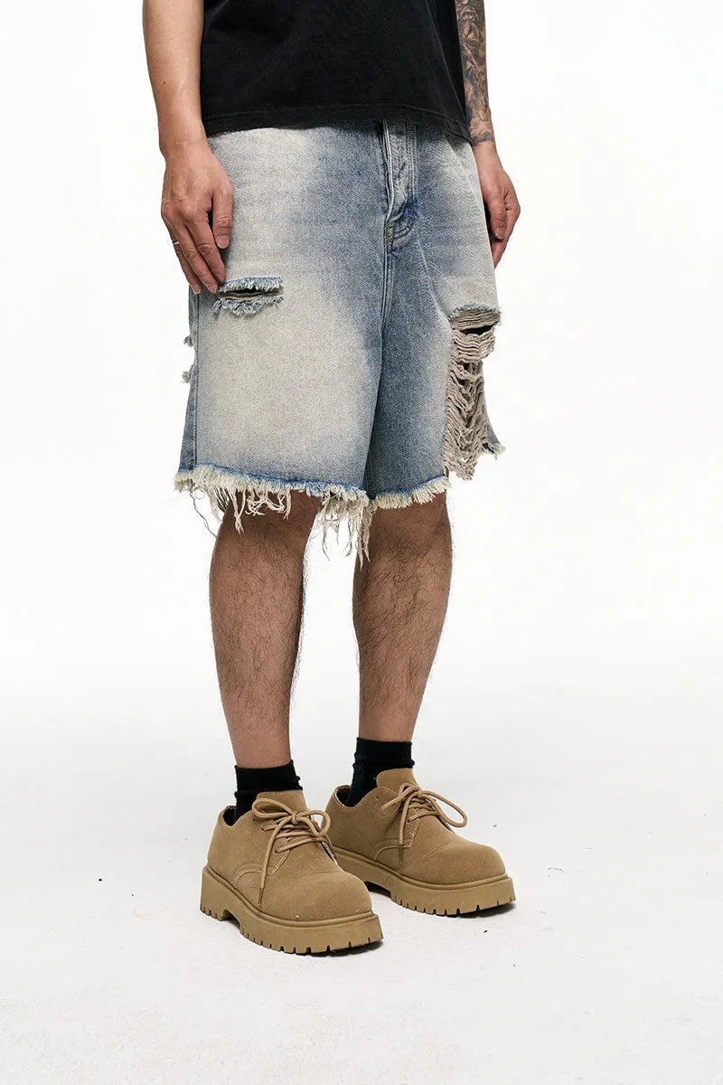 Light blue men's baggy denim shorts with a wide leg and retro washed finish on a mid waist.