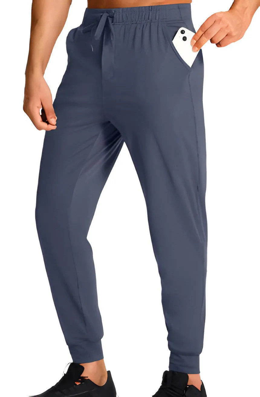 Men's solid colour loose casual trousers in polyester fabric on a hanger.