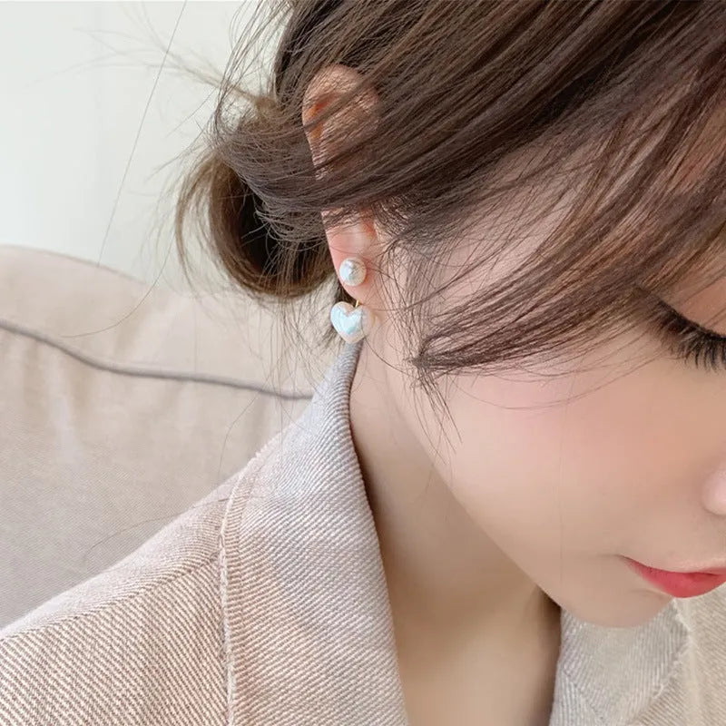 Heart-shaped pearl stud earrings with alloy settings and electroplated metallic finish