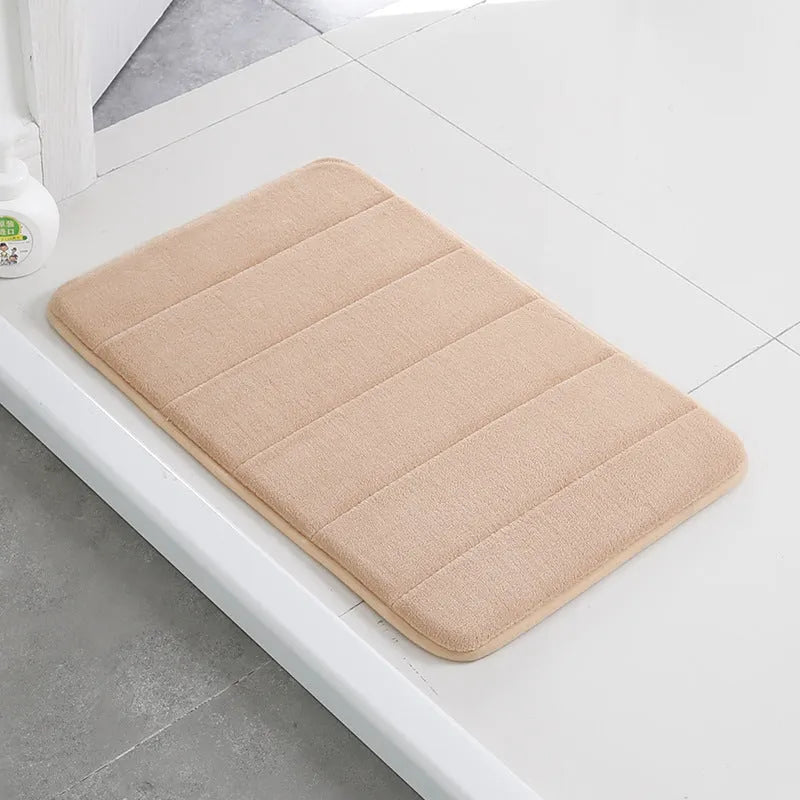 Coral fleece non-slip bath mat in 40x60cm size, placed on bathroom floor with water absorbent surface