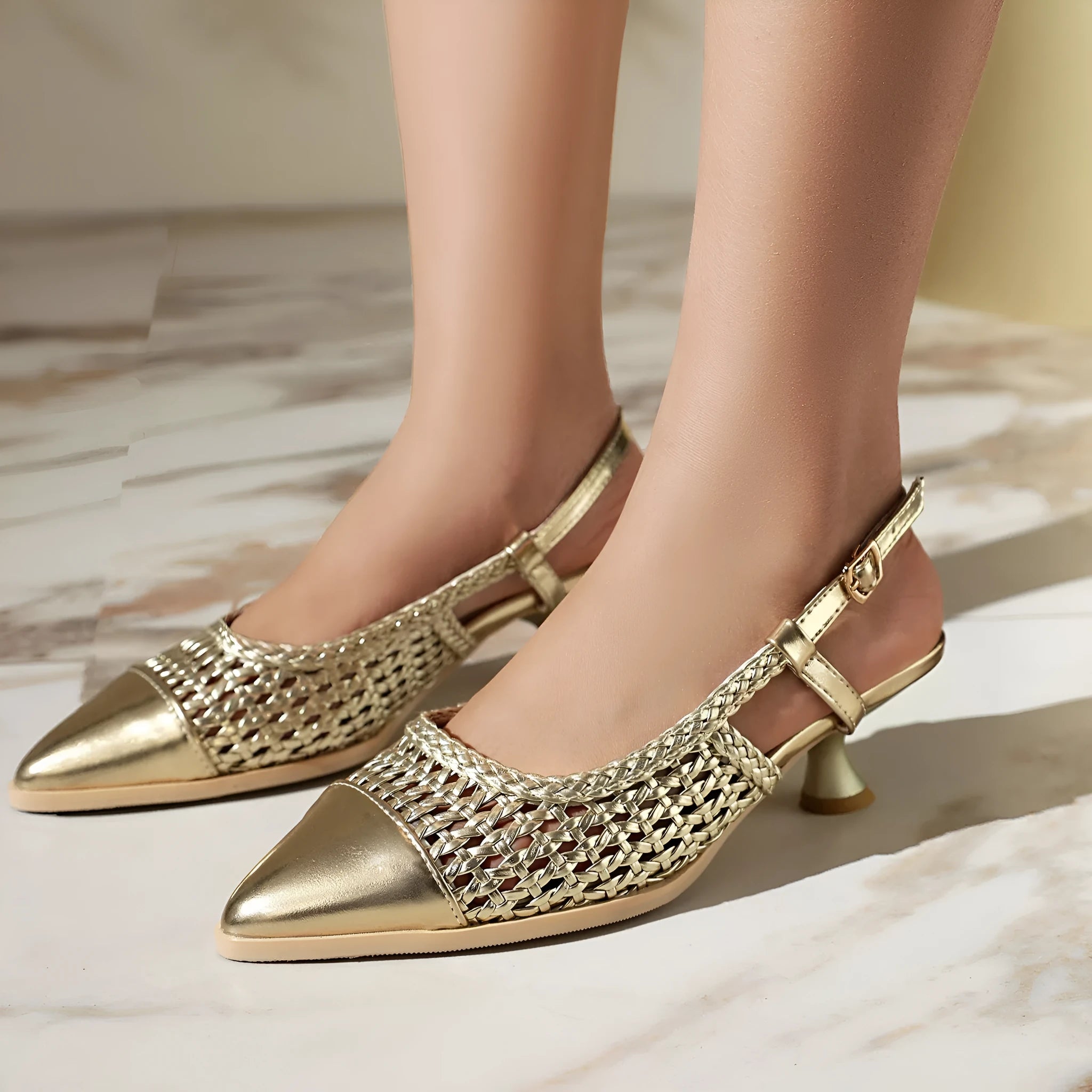 Women's professional sandal with a cat heel, buckle fastening, and metallic upper.