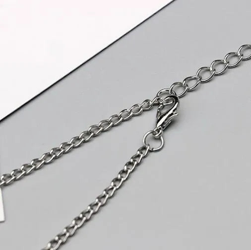 Antique silver hollow flower chain anklet with teardrop shape on a surface, 24cm foot jewellery for women