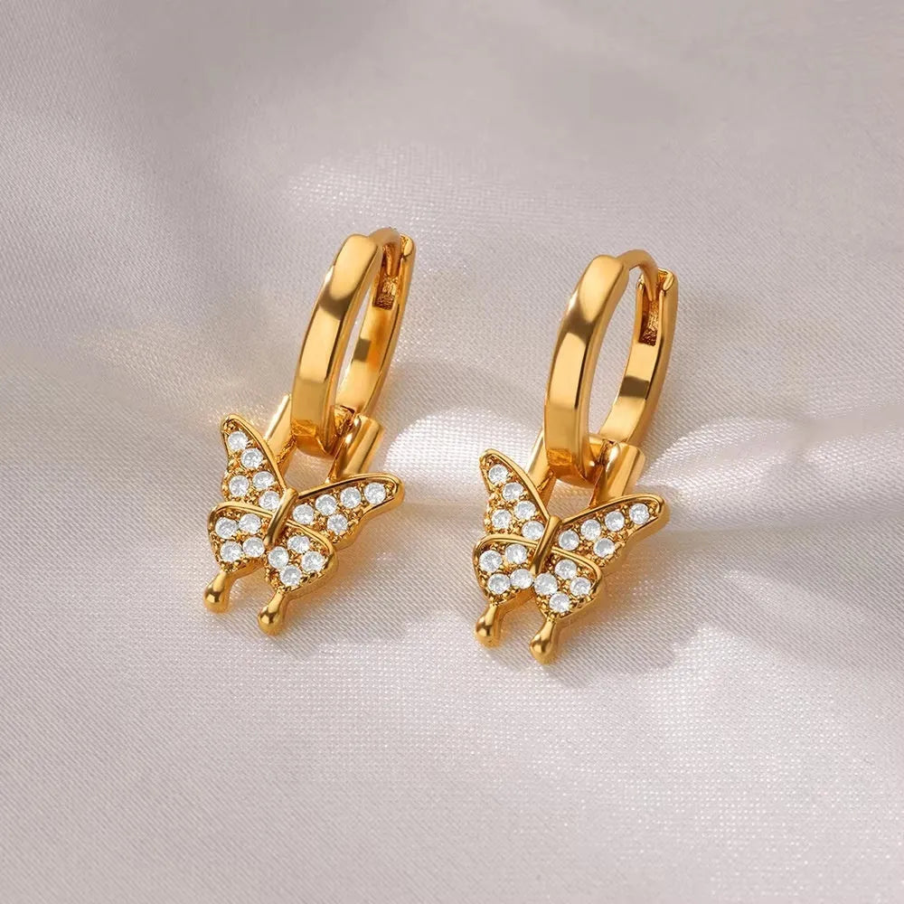 Geometric copper butterfly earrings with a heart, bow, and star details in a selection of colour finishes.