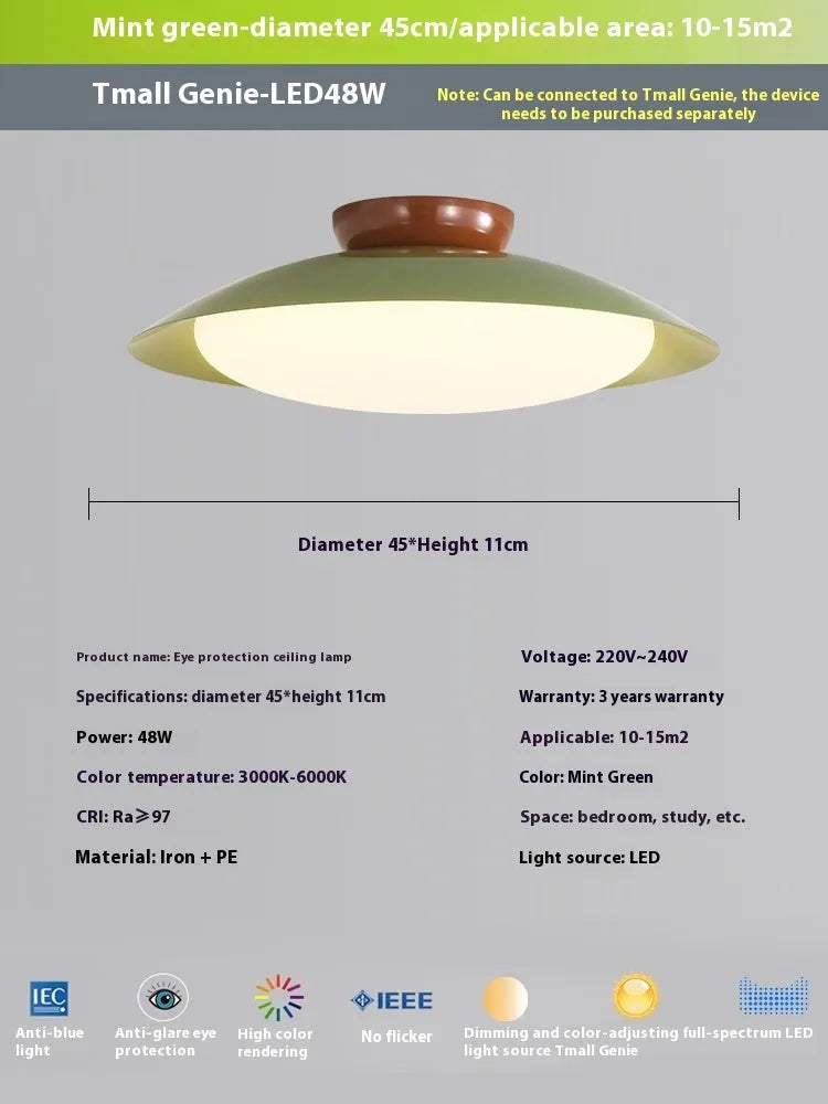 Modern minimalist cream style flying saucer ceiling lamp in mint green on a white ceiling.