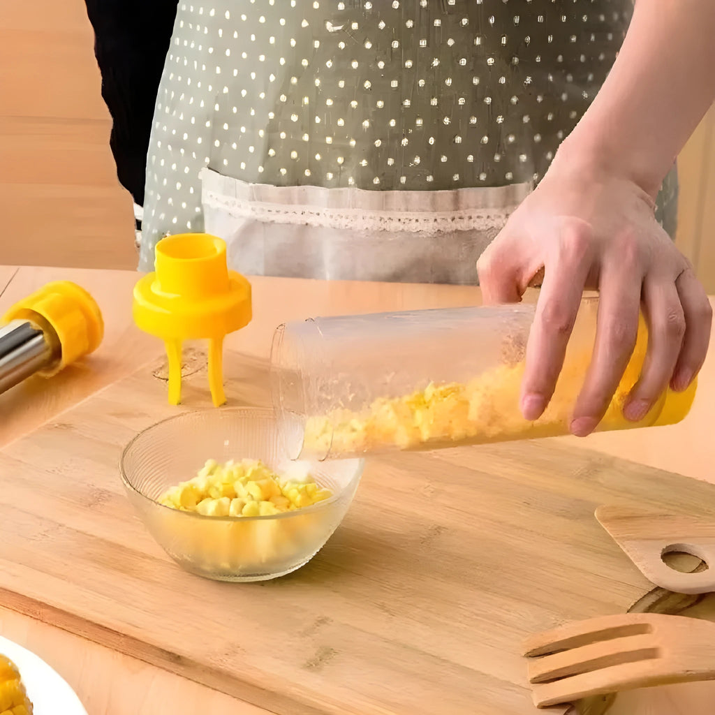Yellow cylindrical corn stripper tool with stainless steel components on kitchen counter