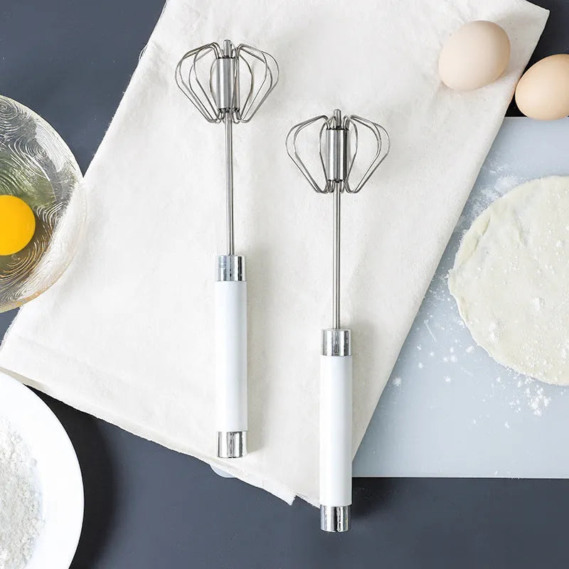 Semi-automatic manual egg beater whisk in stainless steel and white plastic