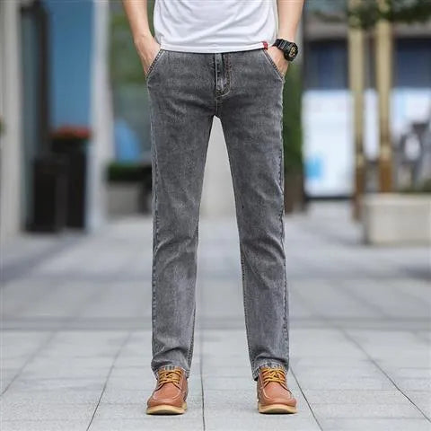 Men's straight-leg smoky gray jeans with low-rise waist and zip fly.