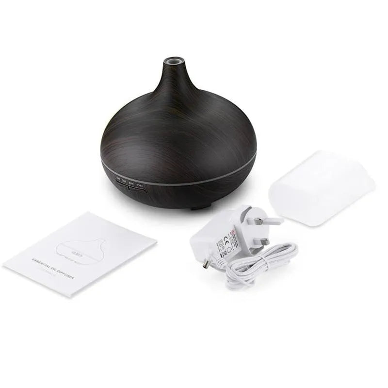 Round 550ml ultrasonic aromatherapy humidifier in white with mechanical control on desk