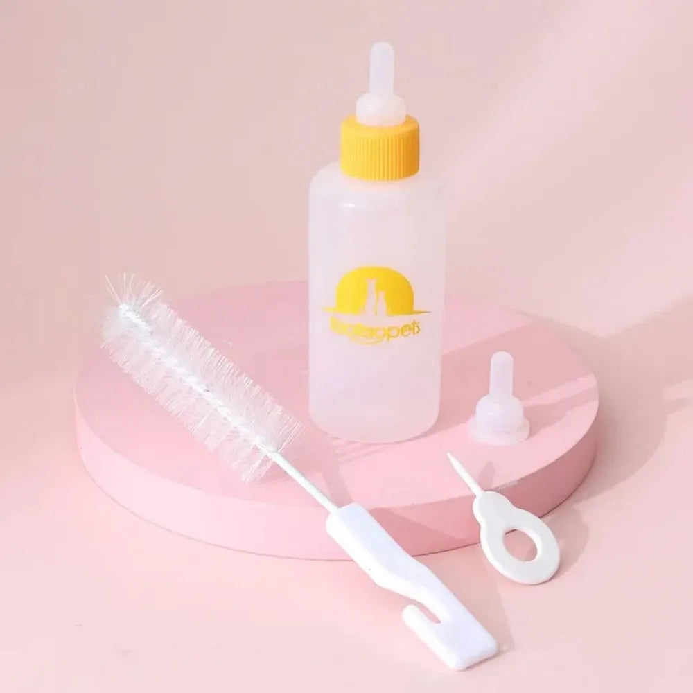 Set of four coloured pet milk bottles with a cleaning brush for feeding newborn puppies and kittens.