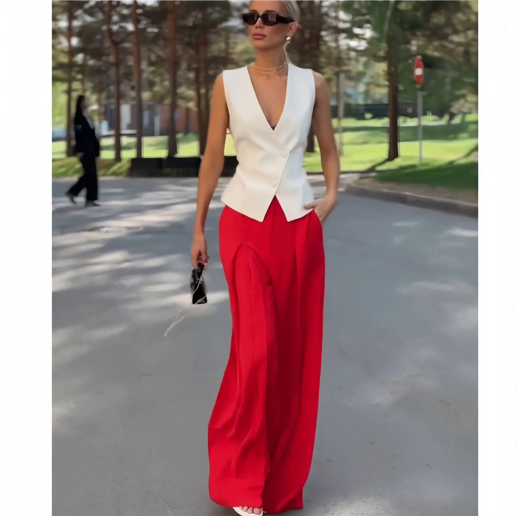 Women's beige two-piece set with deep V-neck sleeveless top and high-waisted wide leg trousers.