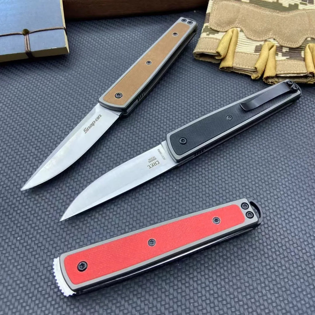 Closed and open views of a folding fruit knife with stainless steel blade in black, brown, or red handle options.