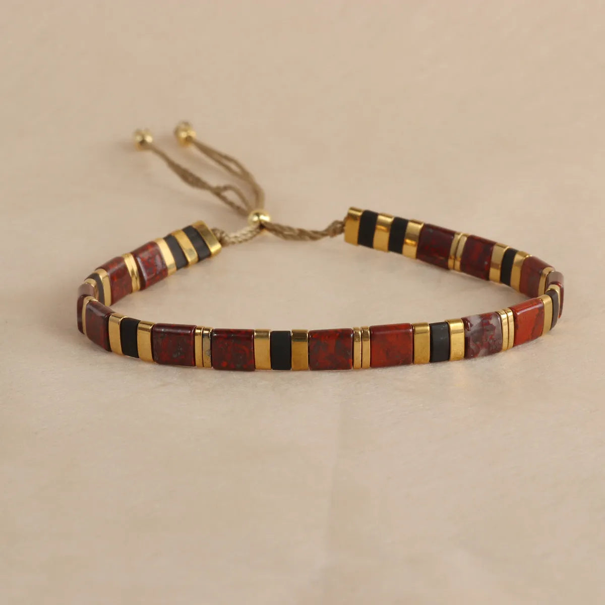Geometric round glass bead bracelet in milky white, black, green, blue, or red.