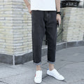 Men's black loose straight harem jeans with elasticated waistband and tapered leg opening