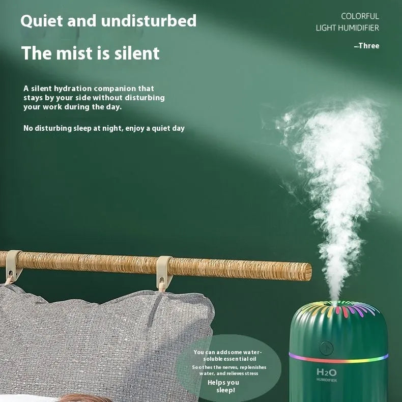 Mini green car-shaped USB aromatherapy humidifier with compact plastic housing on a white background.