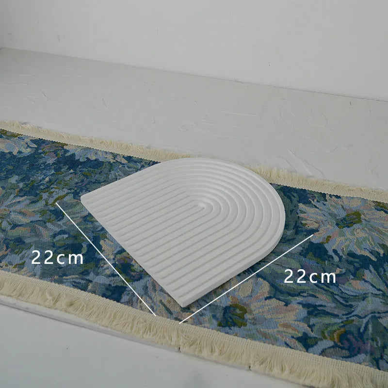 Handmade plaster jewellery display tray with necklaces and bracelets on a countertop