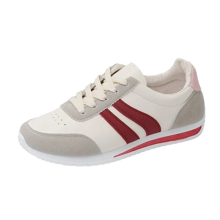 Red low-top lace-up running sneaker with round toe and rubber sole.