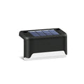 Black solar stair light with ABS housing on outdoor steps, 75x44x42mm IP55 rated