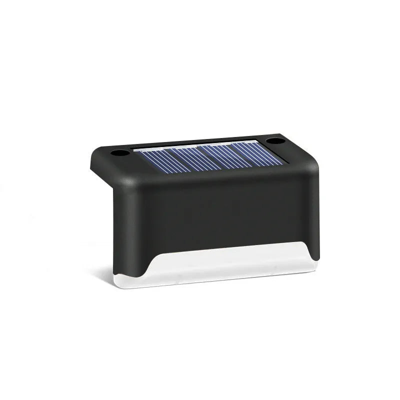 Black solar stair light with ABS housing on outdoor steps, 75x44x42mm IP55 rated