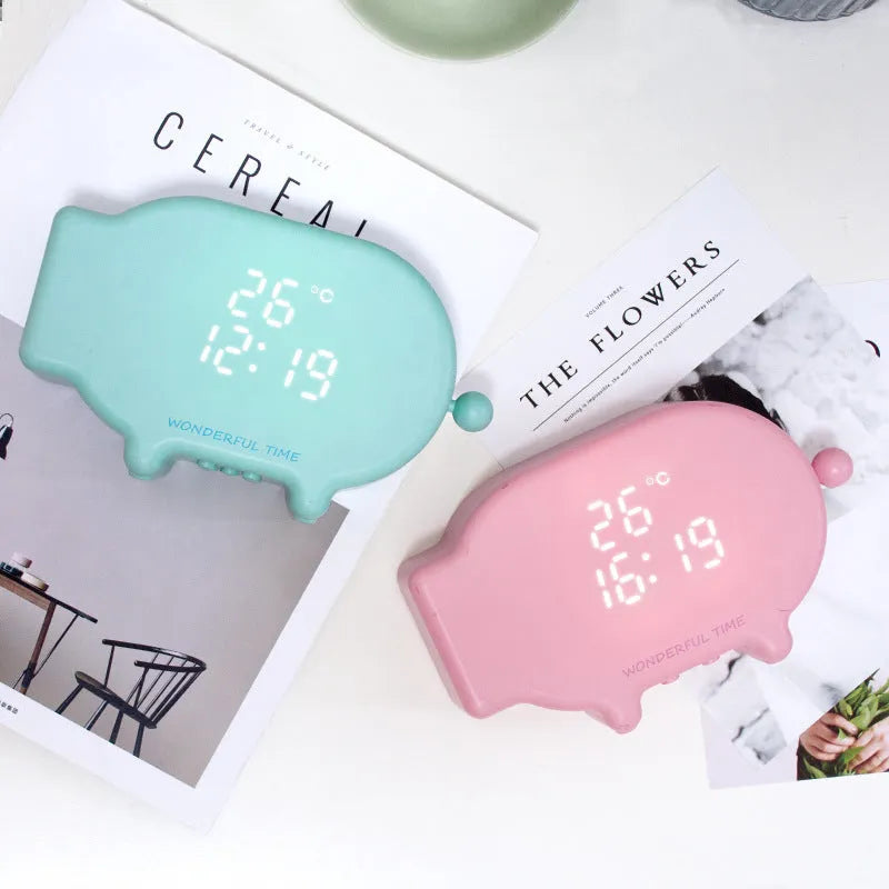 Blue and pink multifunctional LED alarm clock showing time and temperature with USB charging port