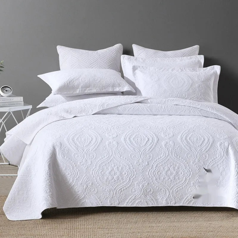 Pure cotton double-sided bed cover three-piece set in a plain colour laid on a bed.