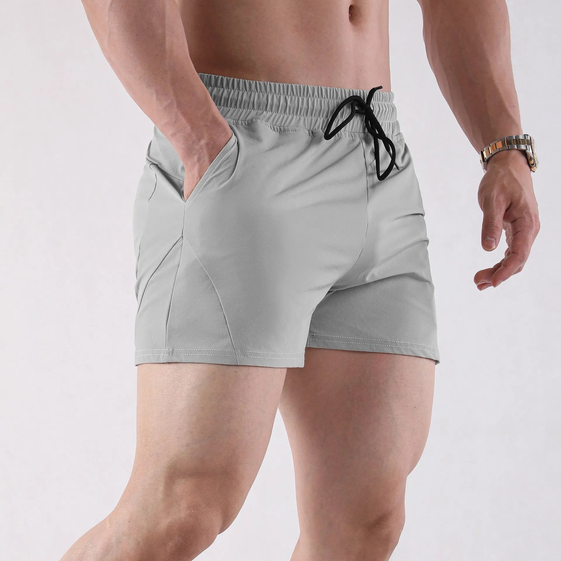 Men's grey thin polyester basketball shorts with an elastic waistband on a white background