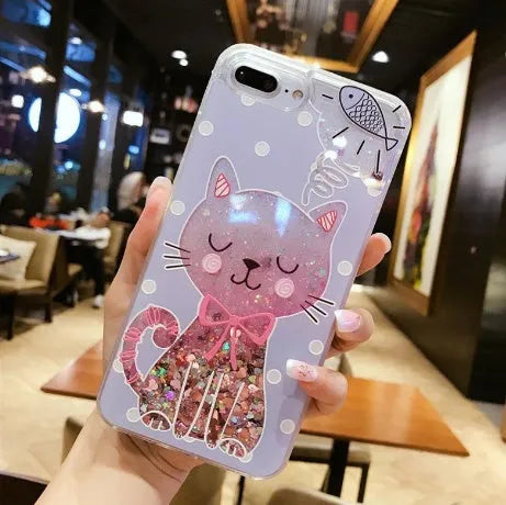 Four glittery cat design phone cases for iPhone models 6 to X on a table.