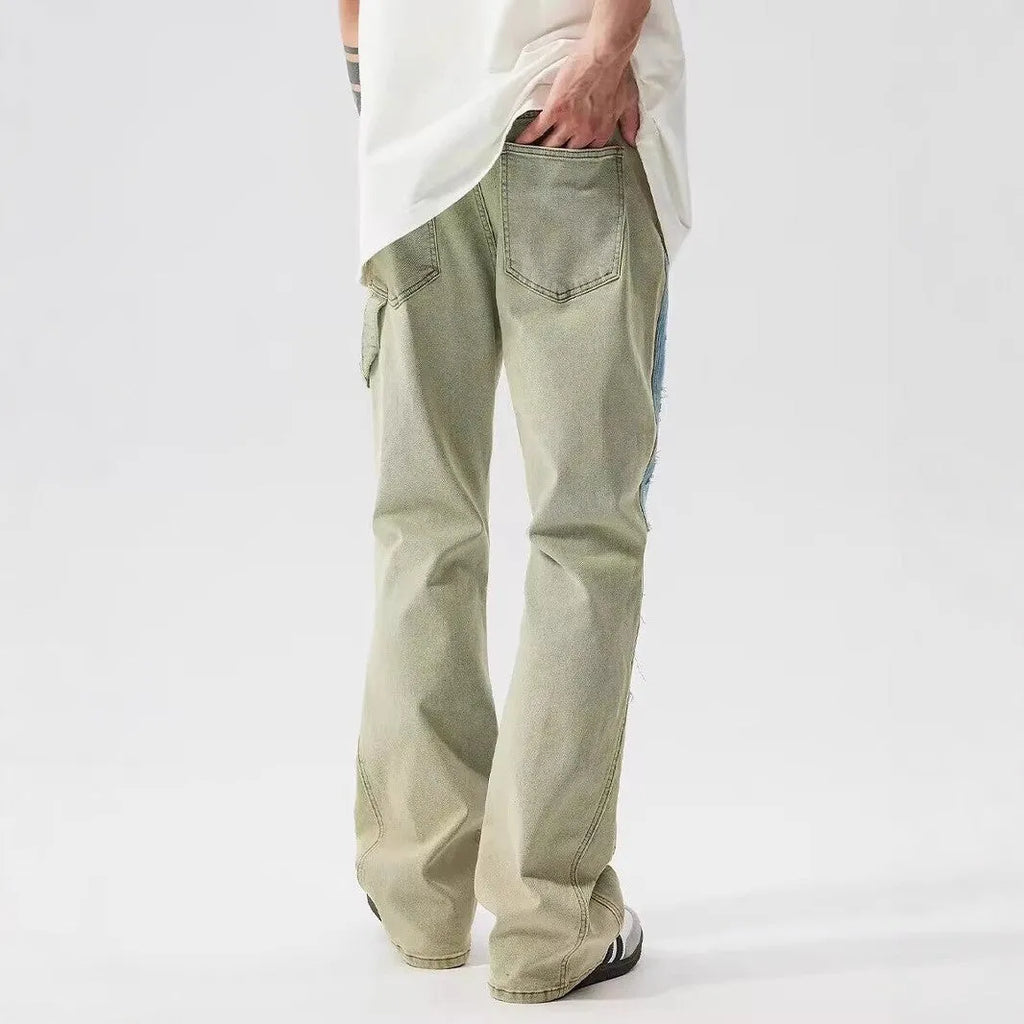 Yellow and blue retro patchwork distressed jeans with splash-ink design details on mid-waist denim trousers