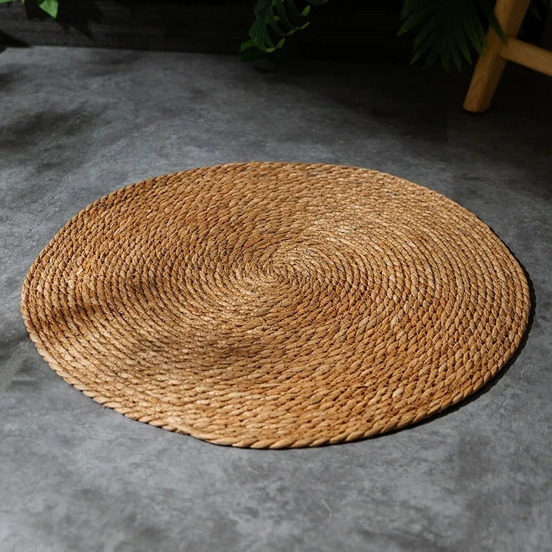Natural papyrus round rattan cat scratching pad in winter brown colour on floor