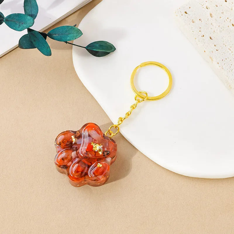 Small natural crystal cat's paw claw charm on a metal loop keychain