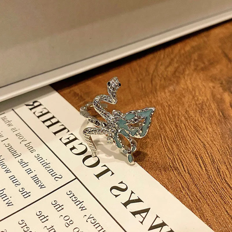 Copper butterfly women's ring with oil-drip finish showing open-loop design