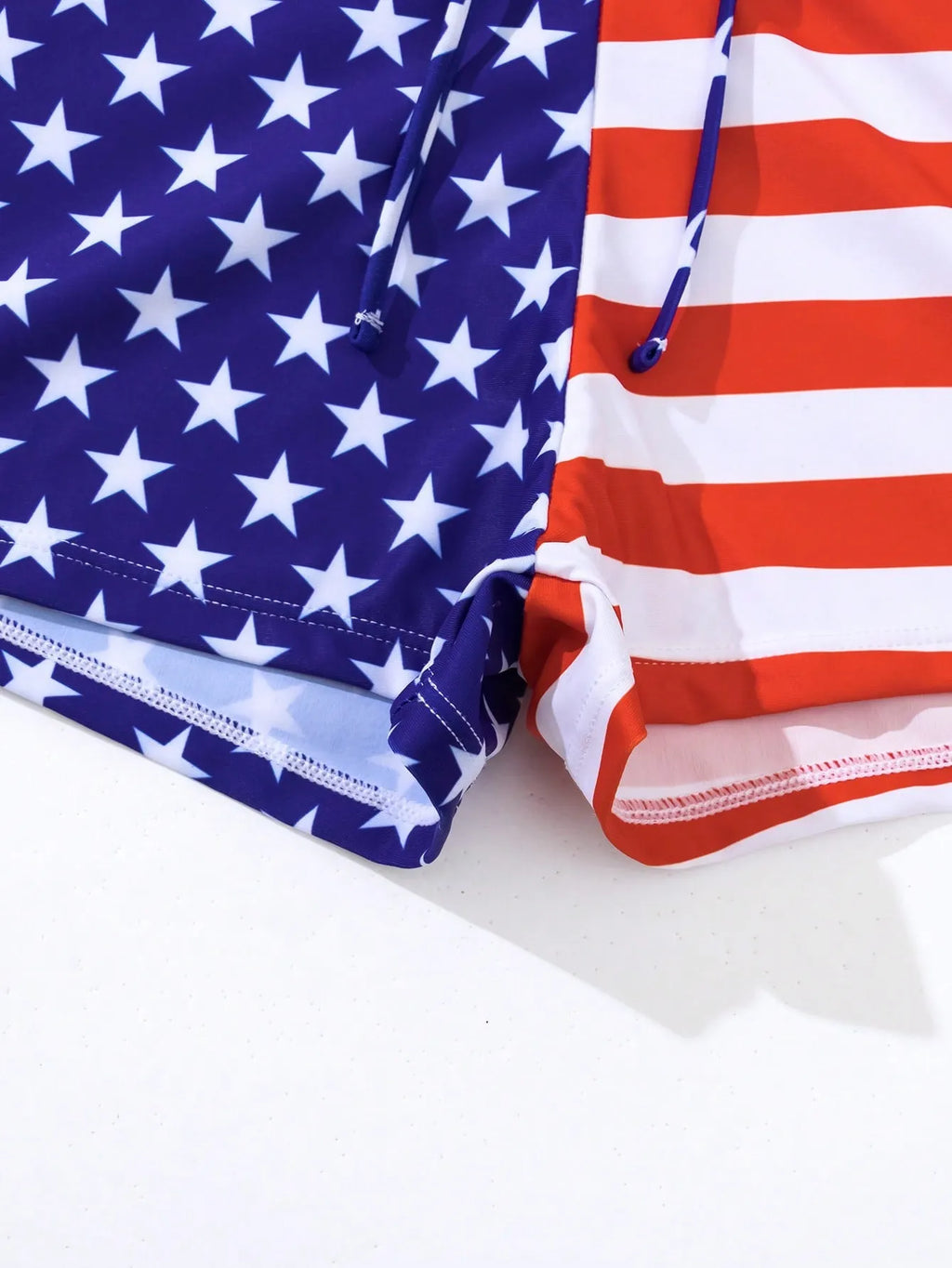 Women's high waist swimsuit with stars and stripes pattern and a drawstring waist.