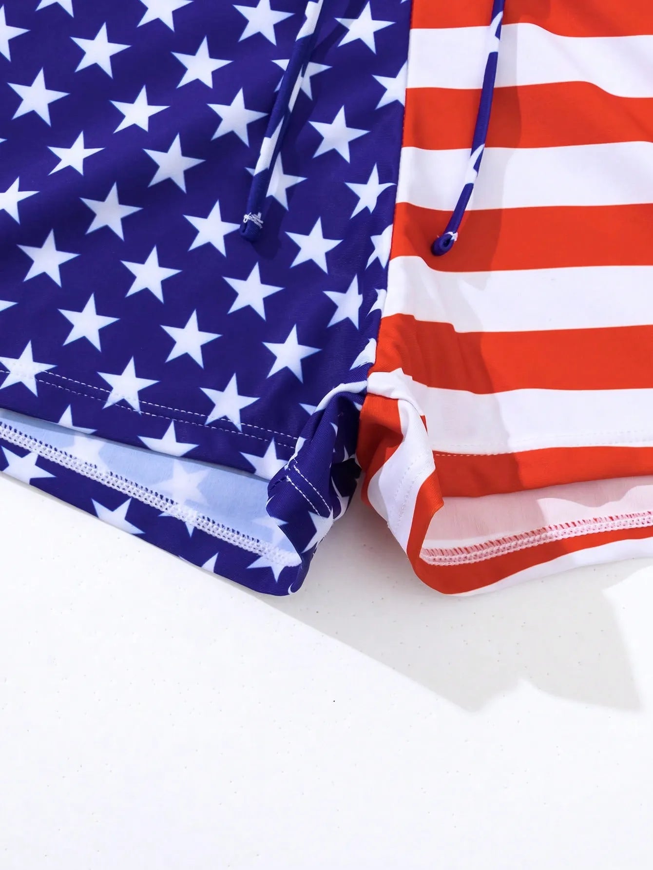Women's high waist swimsuit with stars and stripes pattern and a drawstring waist.