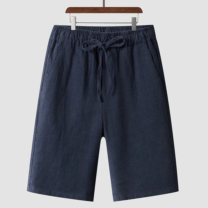 Men's loose-fit linen shorts in a cropped mid-length style with an elastic waistband.