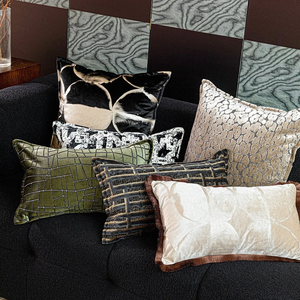 Black gold abstract pattern flannel cushion pillow in square and rectangular sizes on a sofa.