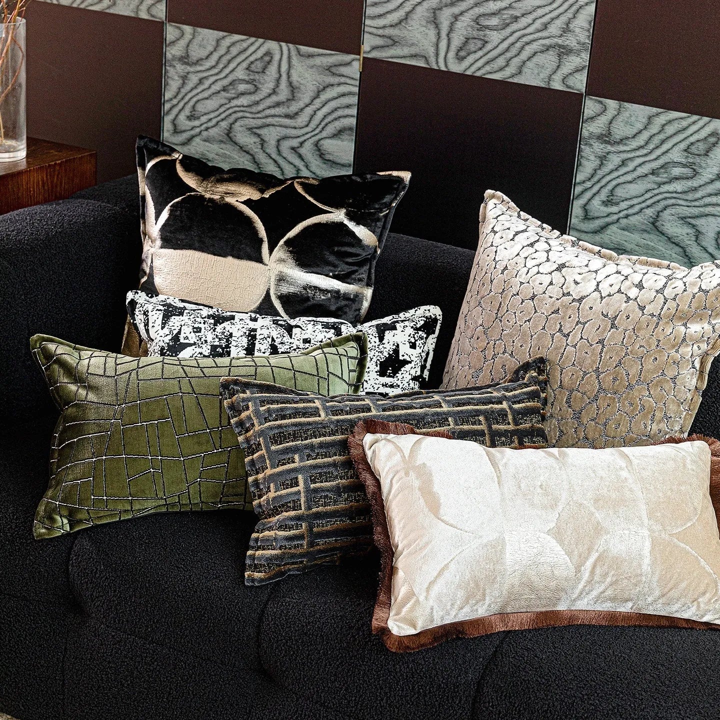 Black gold abstract pattern flannel cushion pillow in square and rectangular sizes on a sofa.